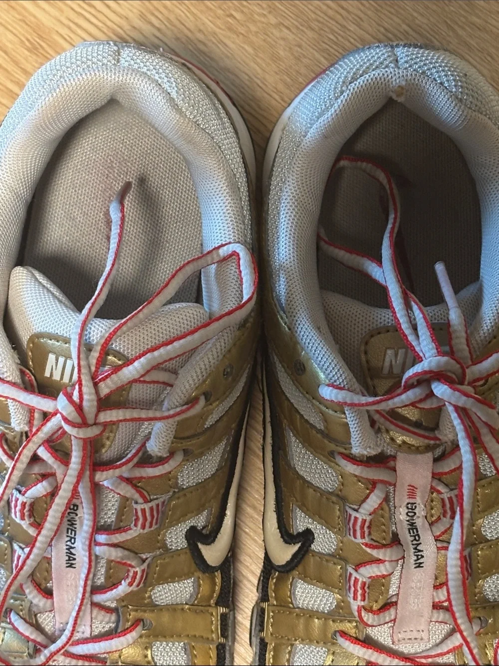 Nike BOWERMAN Metallic Gold, White & Black Athletic Sneakers with Red Details